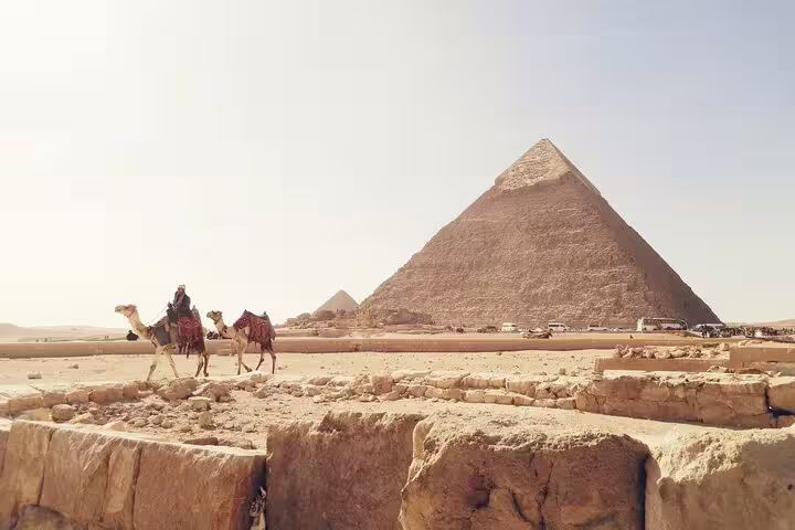 Camel riders by the Great Pyramid of Giza on a private day tour from Port Said to Cairo and pyramids