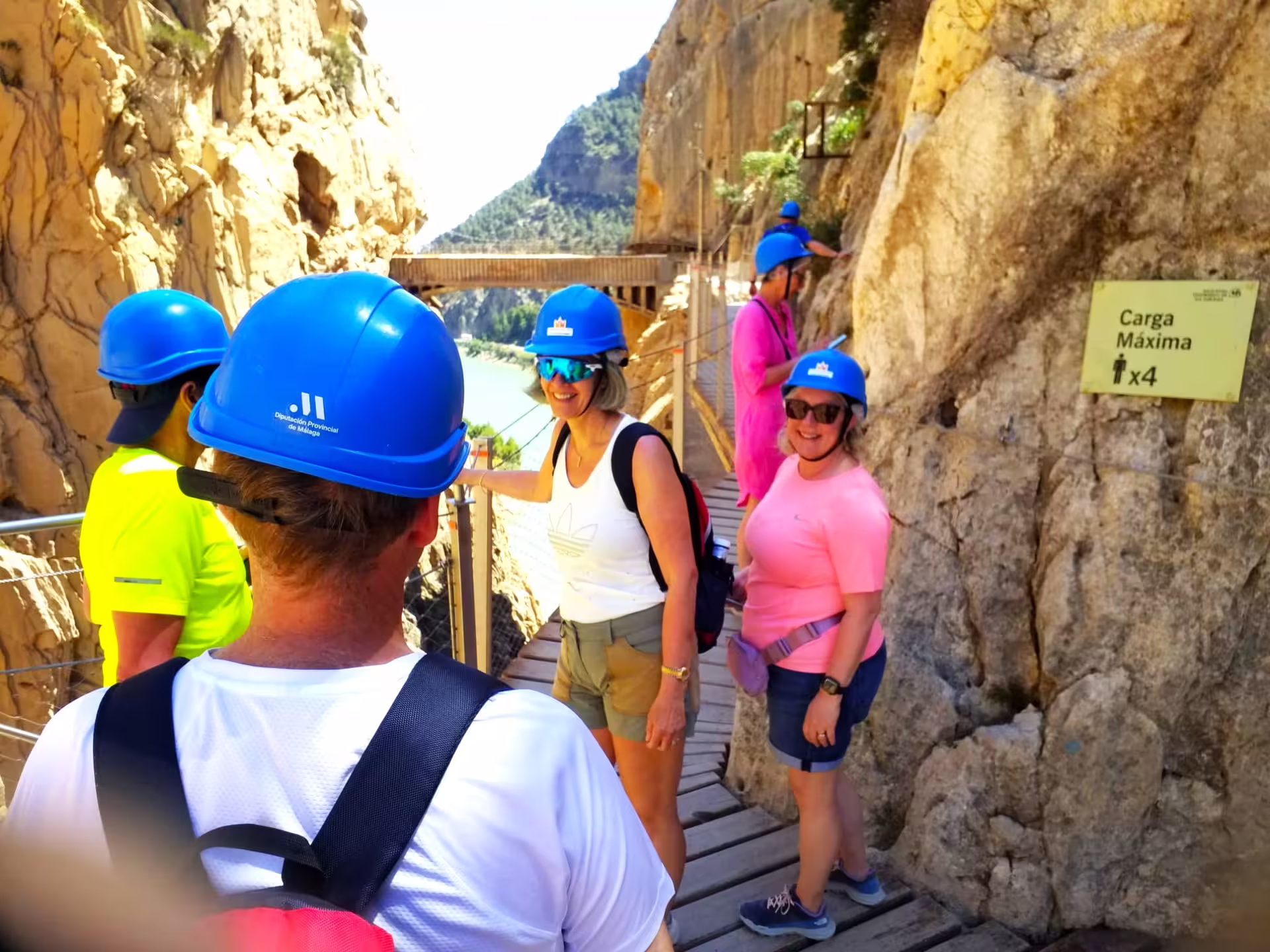 Caminito del Rey guided group walking tour on narrow cliff path near suspension bridge, El Chorro, Malaga