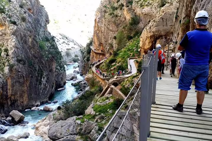 Hikers on Caminito del Rey cliff path above Guadalhorce River gorge, private tour from Marbella or Malaga