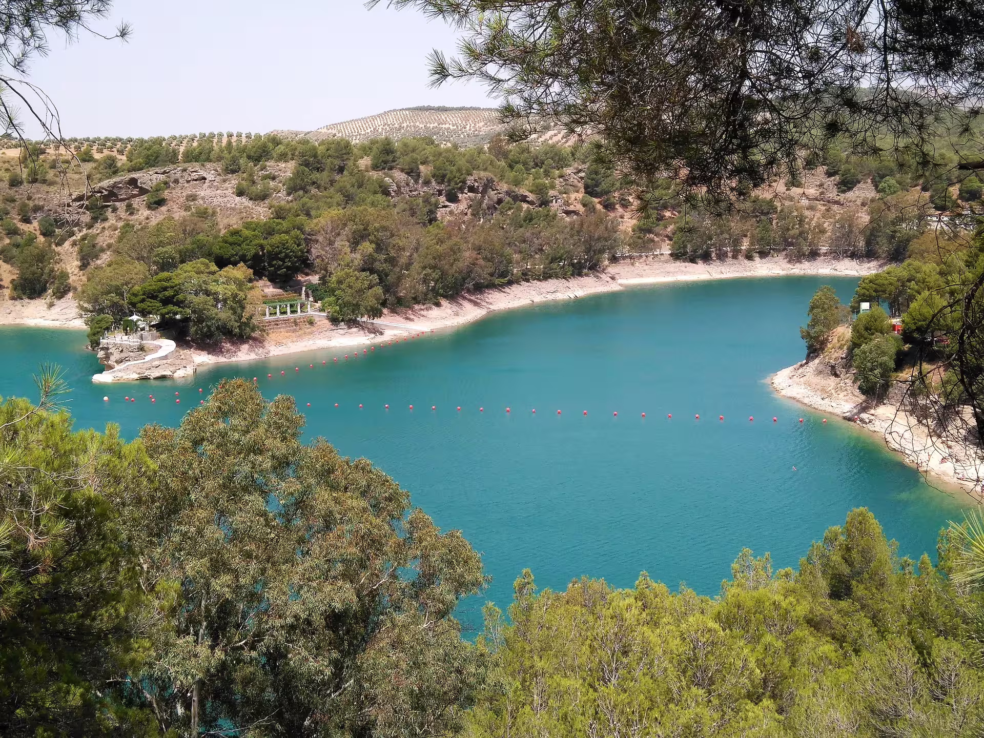 Turquoise reservoir panorama near Caminito del Rey group walking tour route in El Chorro, Malaga, Spain