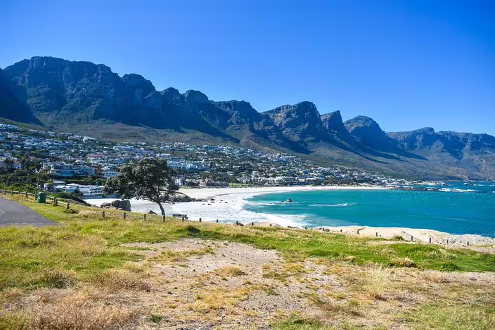 Breathtaking Camps Bay beach with turquoise waters and mountains, a must-see on your Cape Town private tour.