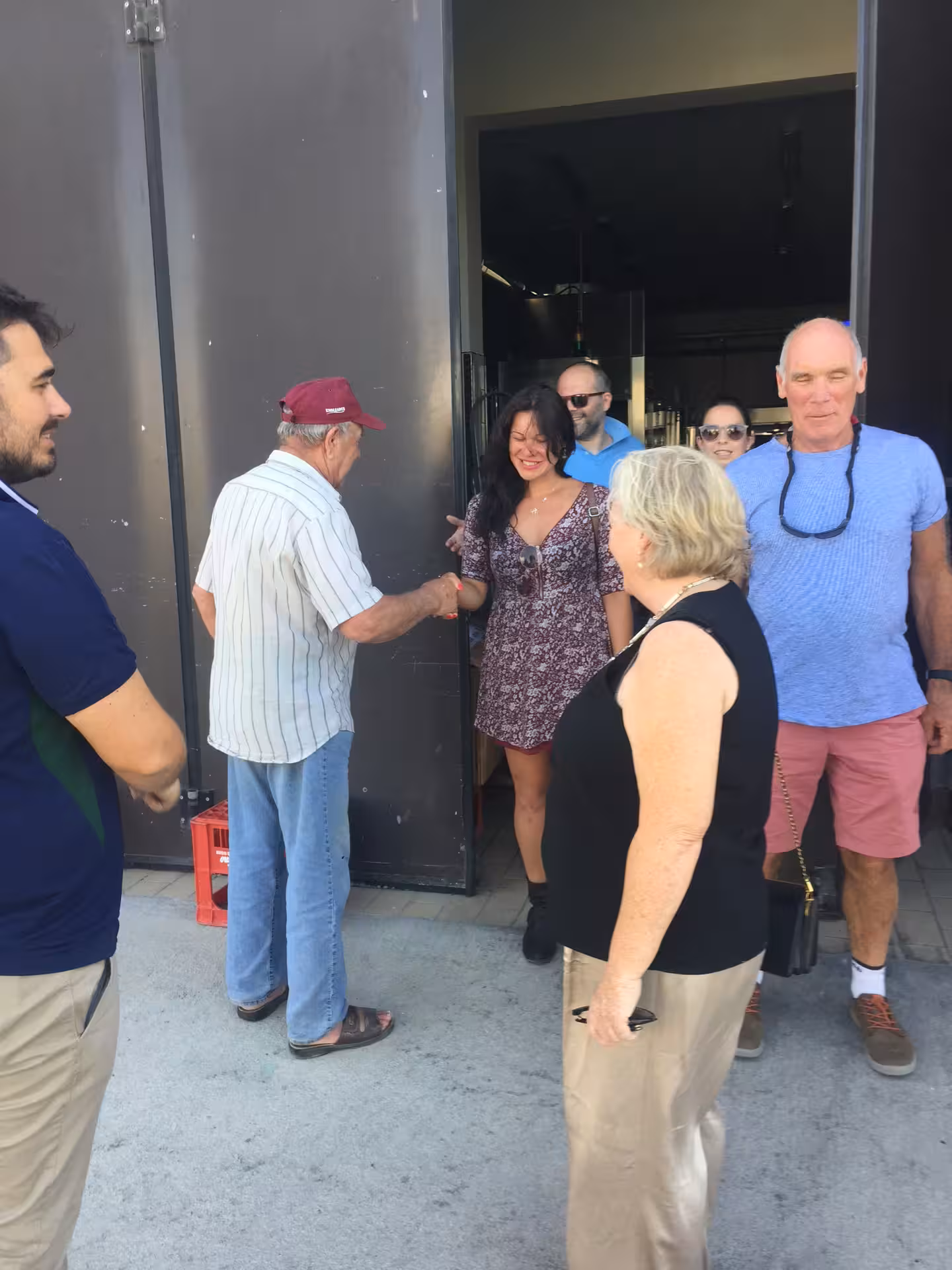 Visitors welcomed at Cantine Mucci winery entrance before vineyard stroll and guided wine tasting tour in Italy