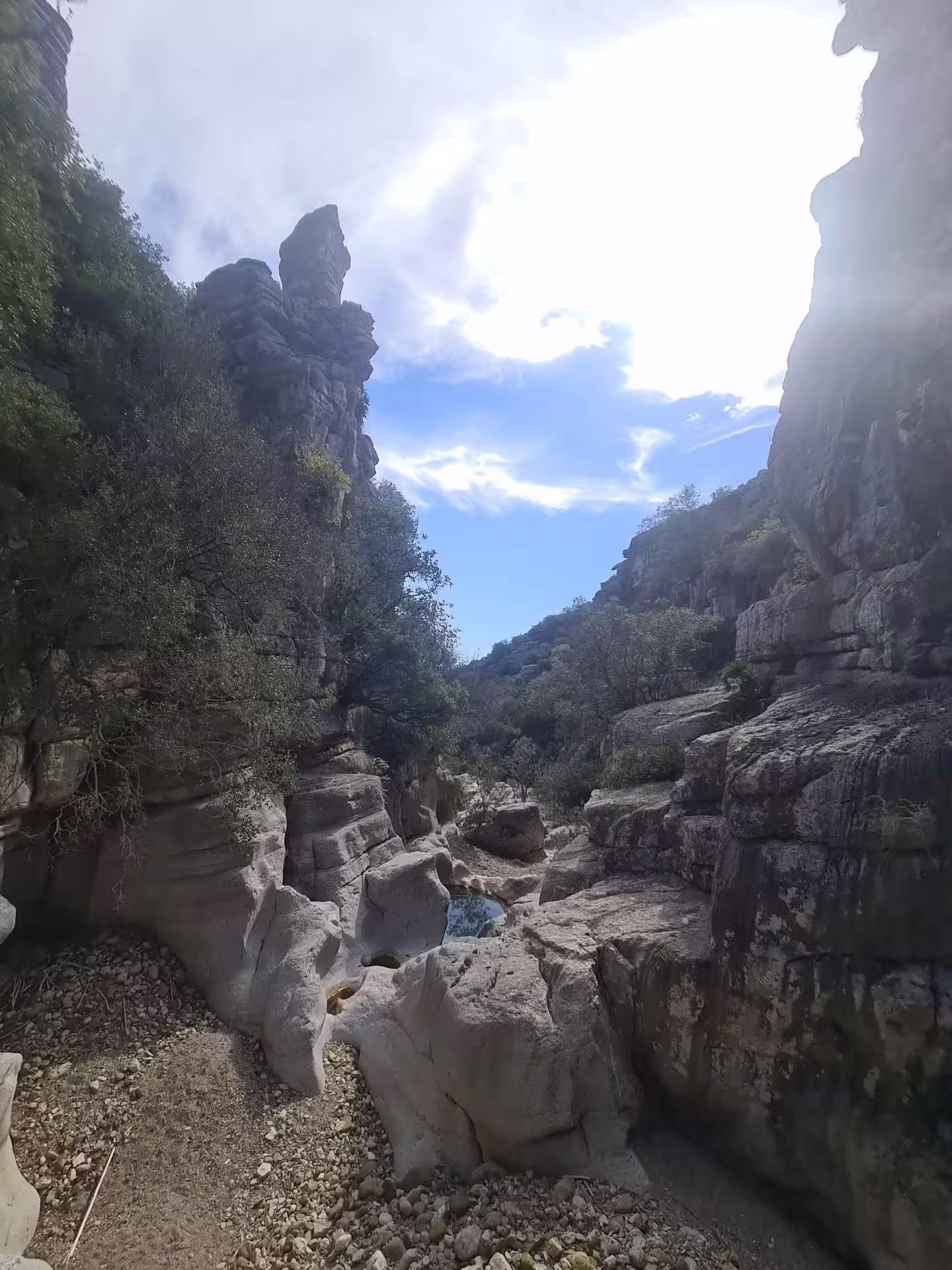 Discover the breathtaking rocky formations and serene pathways of Canuto de la Utrera under a bright blue sky.