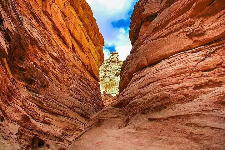Narrow Canyon Salama passage with towering red rocks on Sharm el Sheikh Jeep safari to Dahab, Sinai