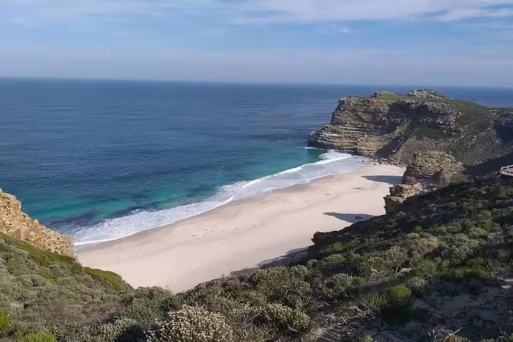 Stunning view of the Cape of Good Hope's pristine sandy beach and cliffs, ideal for nature lovers on a private tour.