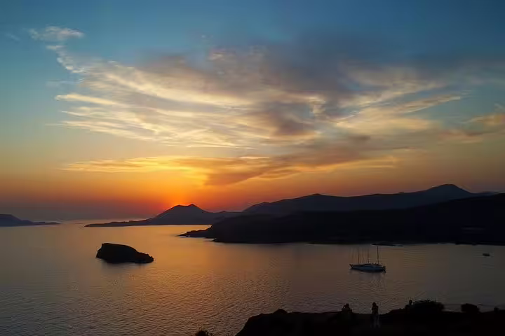 Aegean Sea sunset view near Cape Sounio on a private tour from Athens, golden sky over calm waters