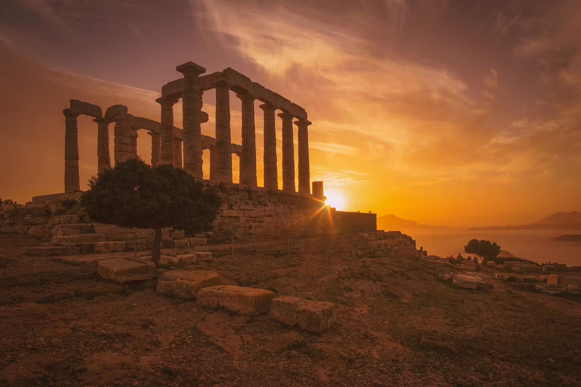 Golden hour view of Cape Sounion Temple of Poseidon ruins by the Aegean Sea on an Athens day tour