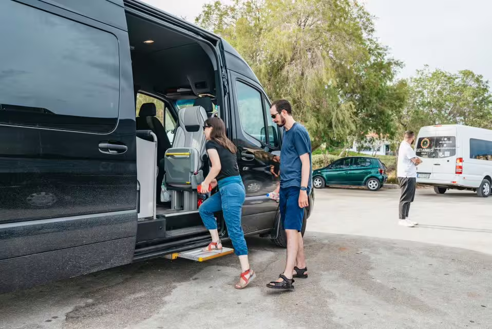 Guests boarding a small-group minibus for the Cape Sounion and Temple of Poseidon sunset tour from Athens