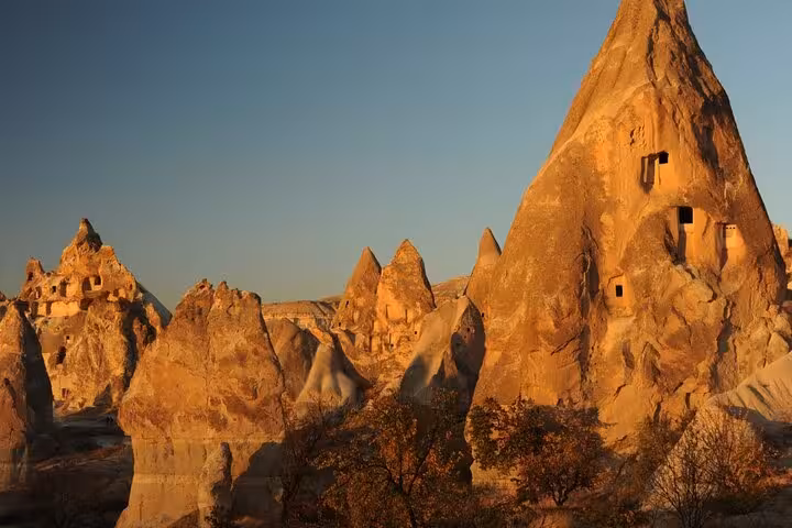 Golden hour view of Cappadocia fairy chimneys in Göreme on an all-inclusive private 2-day guided tour