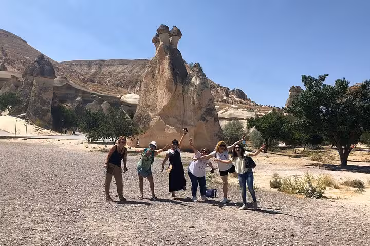 Group photo at Cappadocia fairy chimneys during private sightseeing tour with English speaking guide
