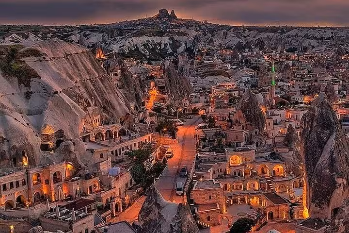 Twilight view of Göreme Cappadocia cave hotels and fairy chimneys on a 2-day small group tour