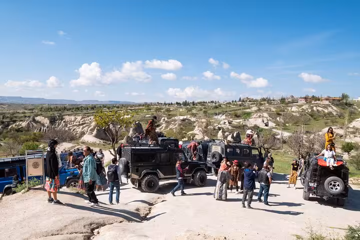 Cappadocia Green Tour group by off-road jeeps at a panoramic viewpoint over valleys and rock formations