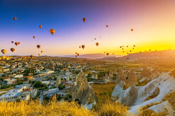 Sunrise hot air balloons over Göreme, Cappadocia on daily tour from Istanbul hotels with panoramic views