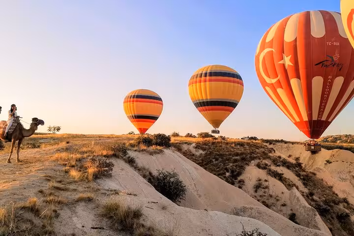 Cappadocia sunrise hot air balloons over fairy chimneys, a top experience on a 6-day Turkey tour from Istanbul