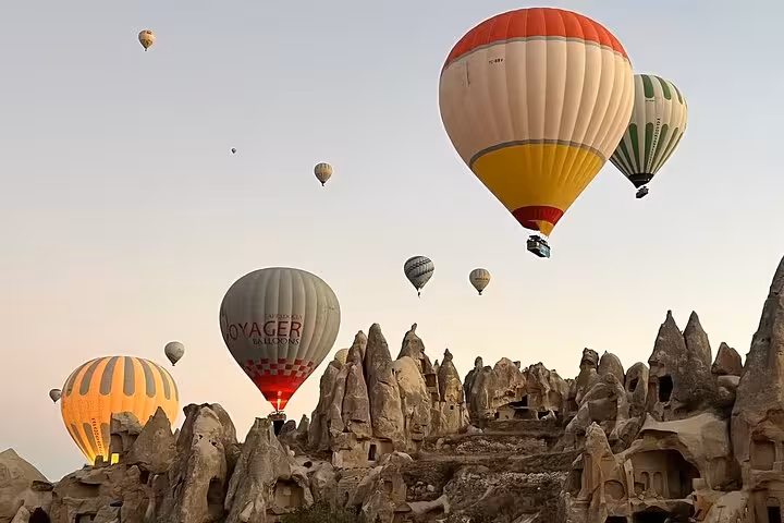 Hot air balloons over Cappadocia fairy chimneys on small group tour, a top Göreme sunrise view