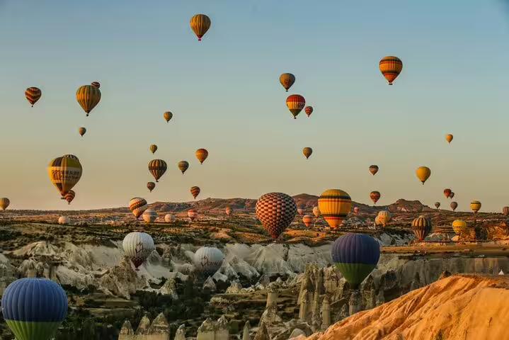 Sunrise hot air balloons over Cappadocia valleys, iconic view on full-day Cappadocia tour from Istanbul by flight