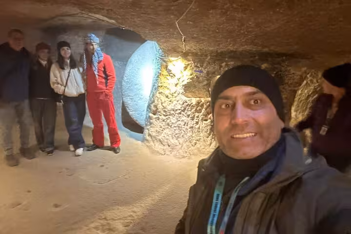 Private Cappadocia day tour guide leads group inside Kaymakli Underground City cave tunnels