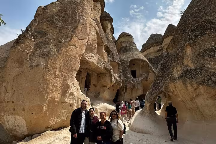 Group exploring Pasabag fairy chimneys and cave dwellings on Cappadocia private day tour by car