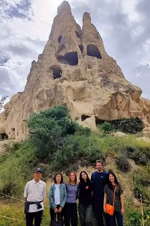 Group photo at Cappadocia cave rock formation on Istanbul to Cappadocia tour with roundtrip flights and hotel
