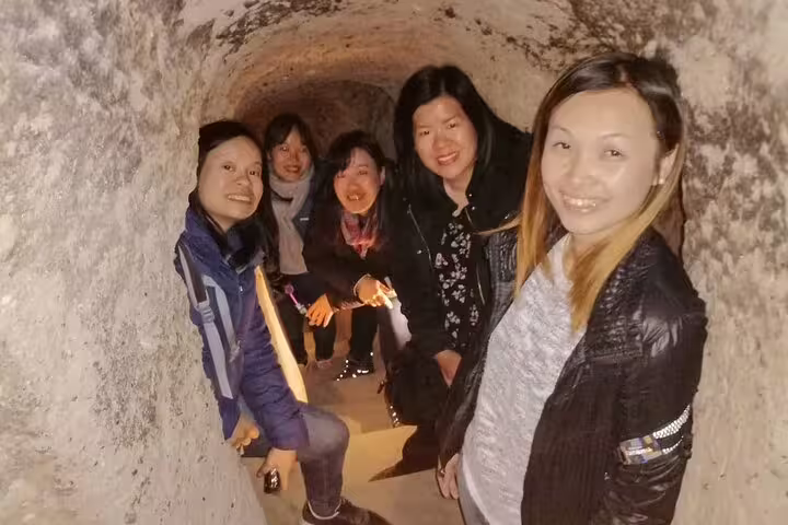 Travelers explore a Cappadocia underground city tunnel on the 7 Churches of Revelation 10-day Turkey tour