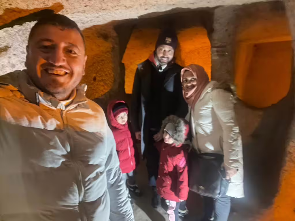 Family selfie inside Cappadocia underground city on small group 7-day Istanbul, Ephesus tour with flights