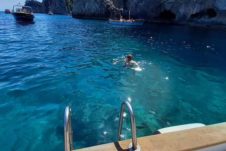 Swim stop in Capri’s crystal-clear Blue Grotto area during a 4-hour private classic boat tour