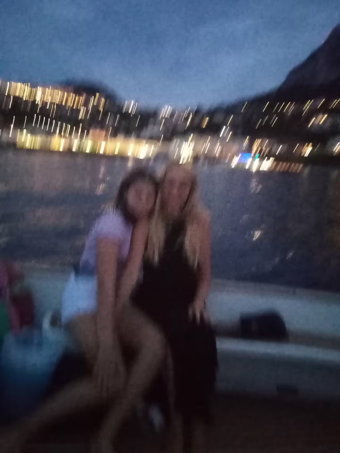 Guests on a boat at dusk with glowing shoreline lights, From Dusk Till Night immersive night experience tour