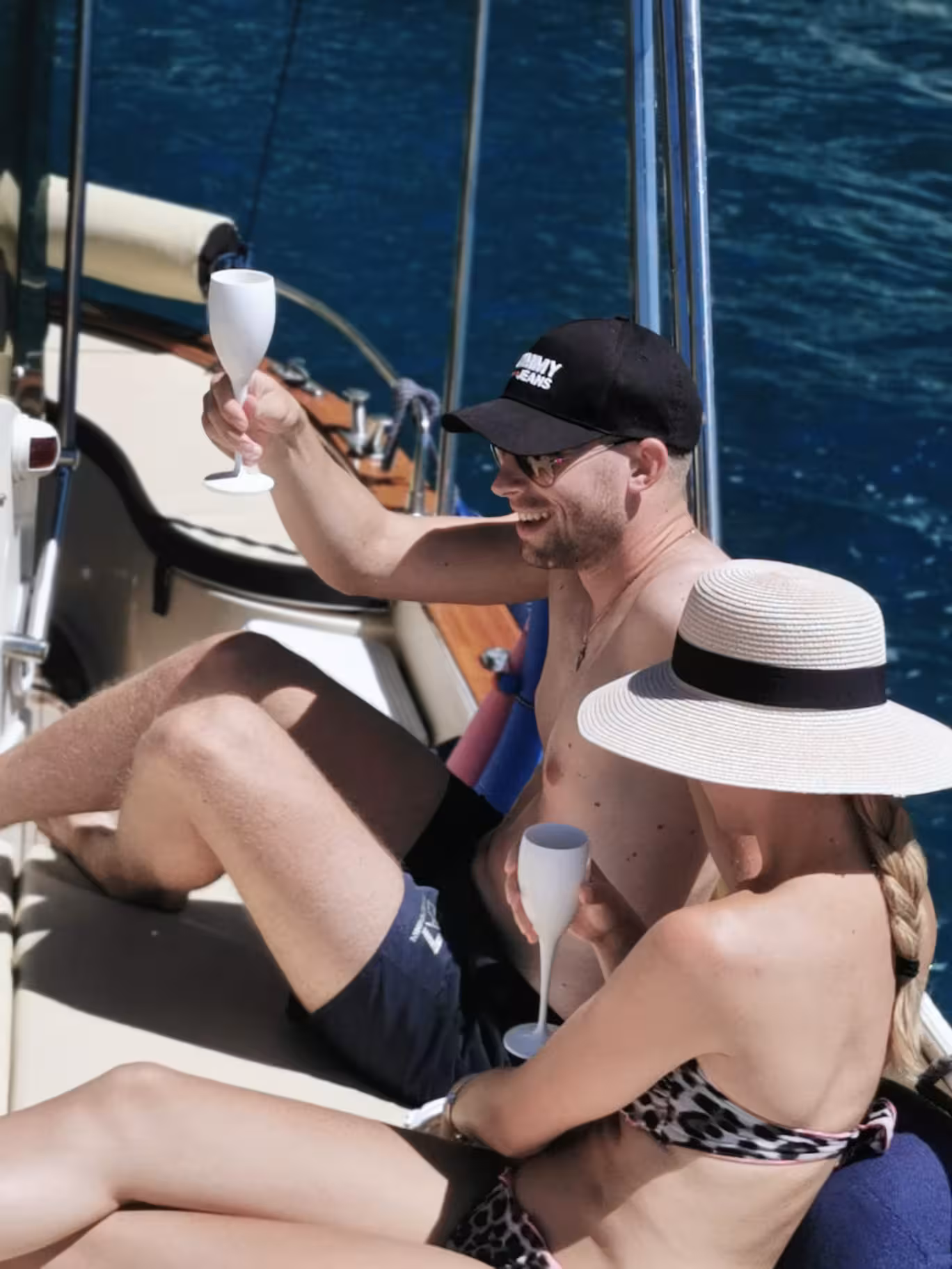 Couple toasting with Limoncello on a Capri boat tour from Sorrento, enjoying the scenic Italian coastline.