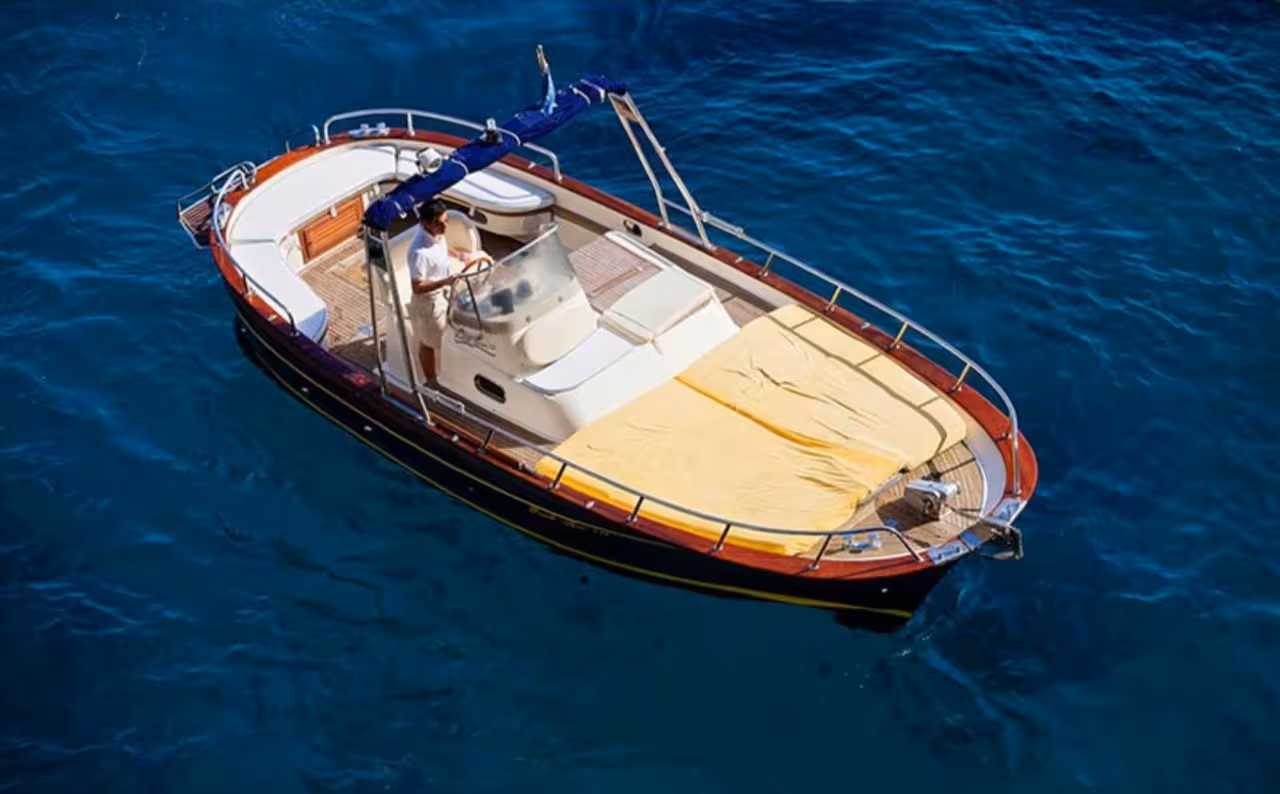 Classic Capri private boat tour with sun deck on turquoise water, perfect for swimming stops and hidden coves