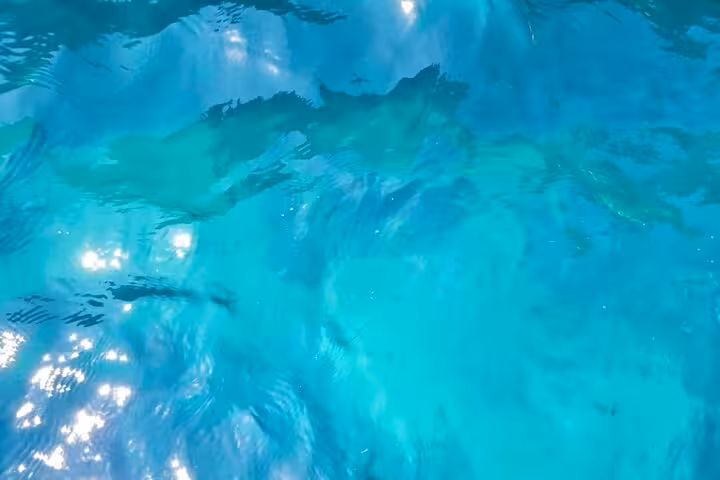 Crystal-clear turquoise waters of Capri, glistening under the sun, perfect for a private boat tour adventure.