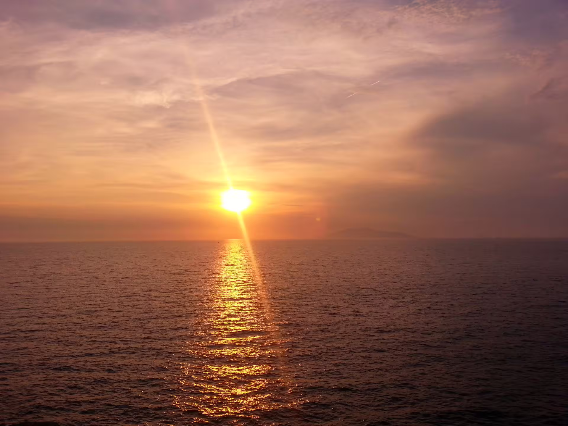 Golden sunset over calm sea, perfect start to From Dusk Till Night immersive night-world experience tour