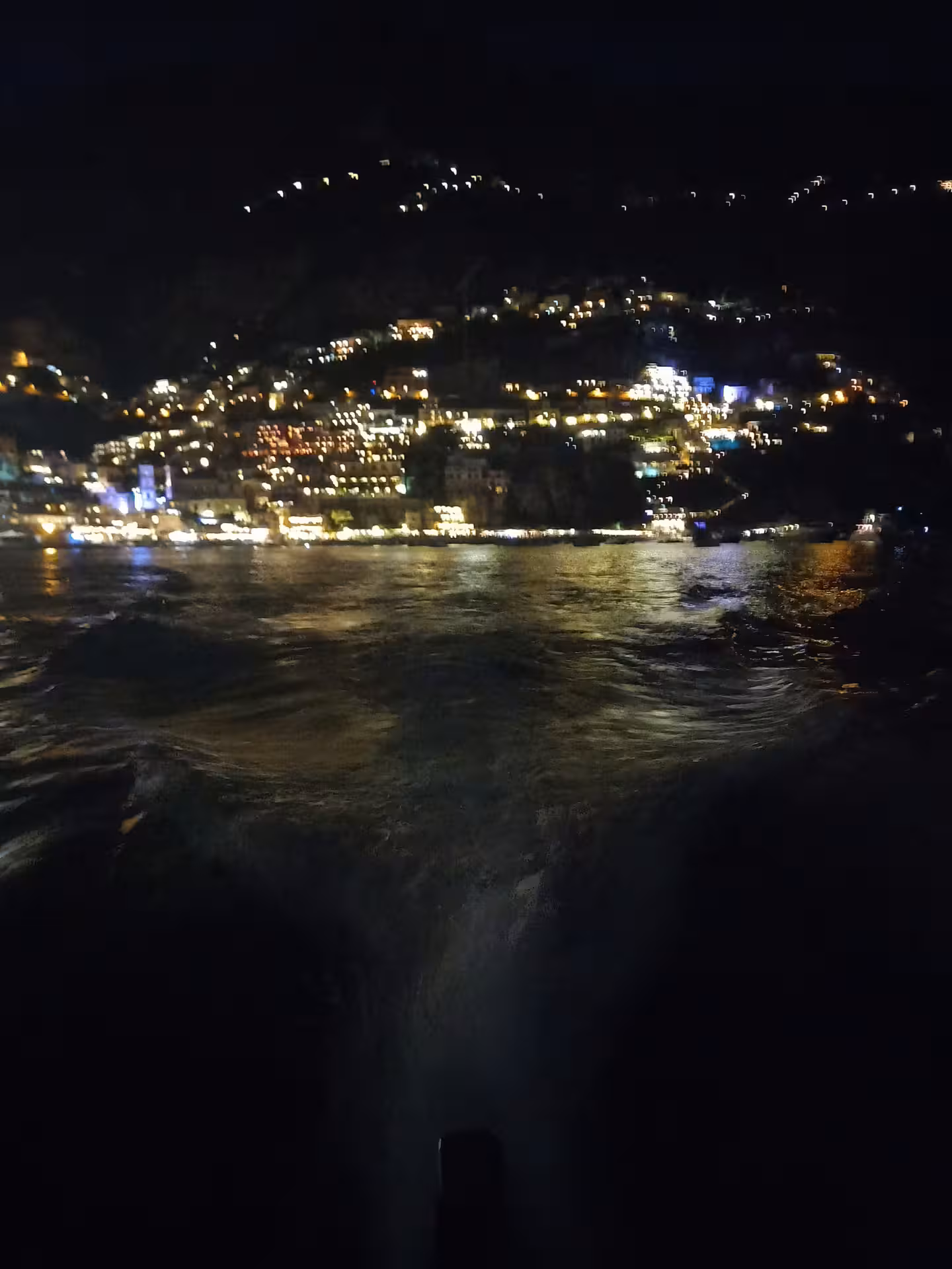 Nighttime city lights reflecting on water during From Dusk Till Night immersive experience, scenic evening view