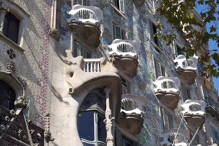 Casa Batlló's ornate balconies and intricate mosaic facade reflecting Gaudi's artistic genius in Barcelona.