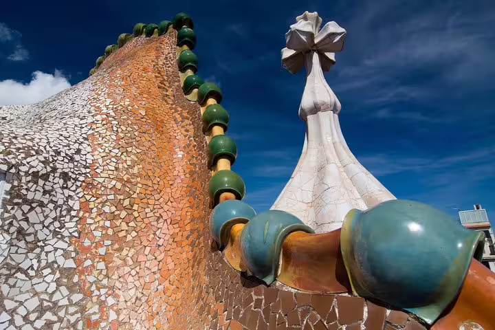 Close-up of Casa Batlló rooftop spine and cross tower in Barcelona, featured on a guided Gaudí morning tour with optional ticket