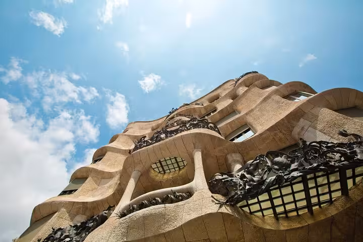 Low-angle view of Casa Milà (La Pedrera) on a full-day private Barcelona panoramic city tour by vehicle