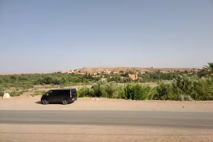 Private 6-day Casablanca to Marrakech desert tour van driving past Draa Valley oasis near Ouarzazate