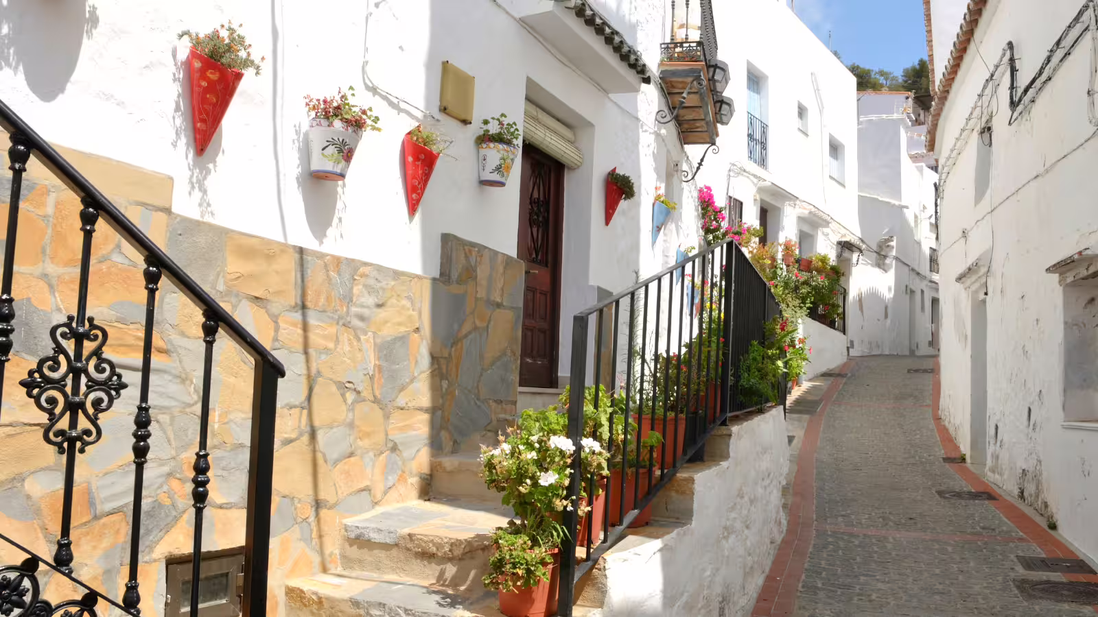 Flower-lined whitewashed street in Casares village on a private tour from Costa del Sol, Andalusia