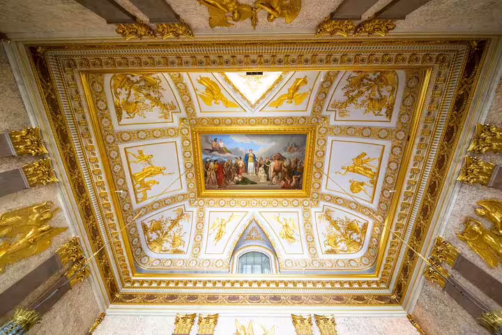 Gilded coffered ceiling with neoclassical frescoes inside Caserta Royal Palace, visited on a private guided tour including shuttle