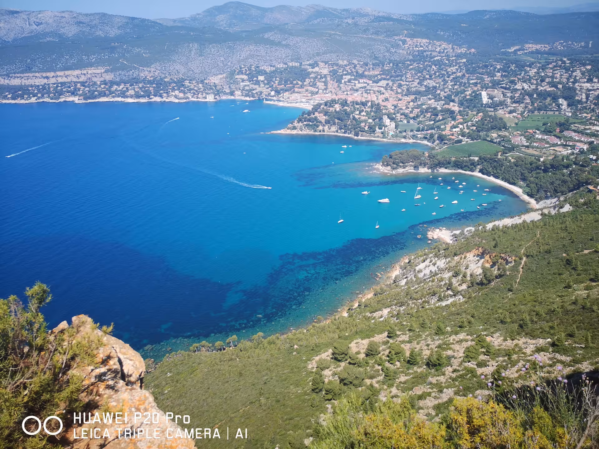 Aerial view of Cassis bay with turquoise water and boats, scenic stop on private day trip from Marseille