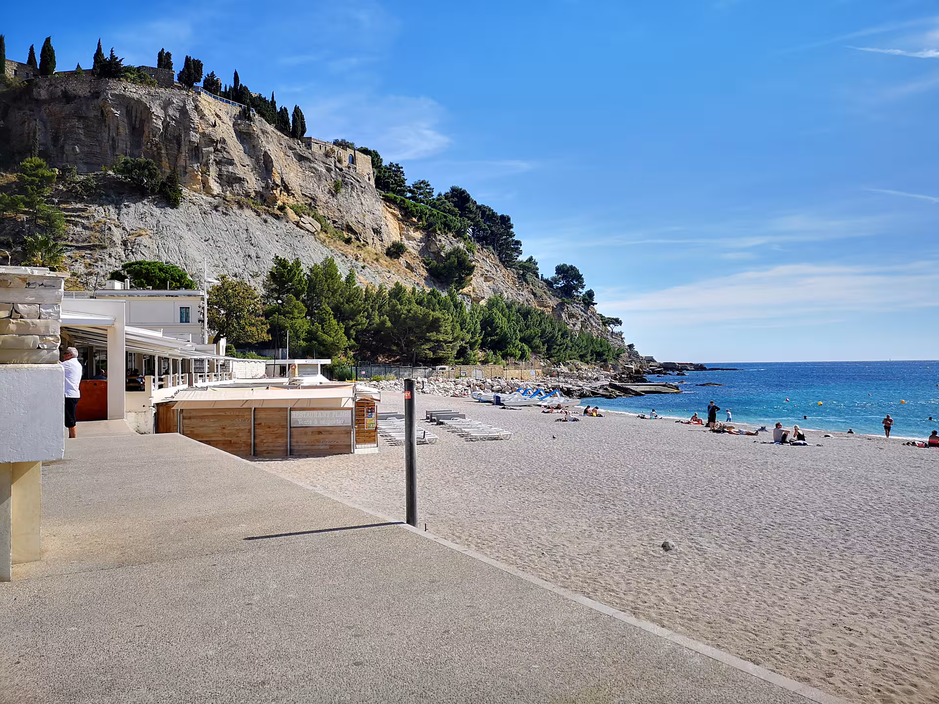 Sunny Cassis beach by turquoise Mediterranean water and cliffs, scenic stop on a private day trip tour