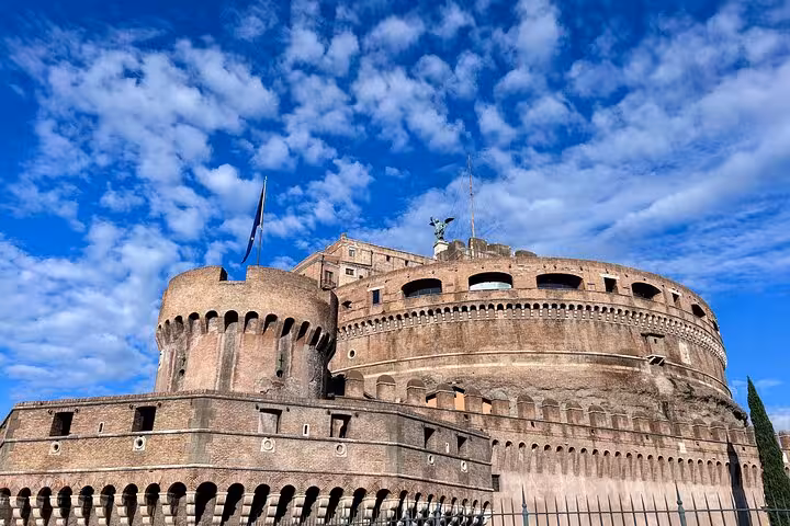Majestic Castel Sant'Angelo under a vibrant blue sky, a must-see on the Rome Highlights Tour with culinary classes.
