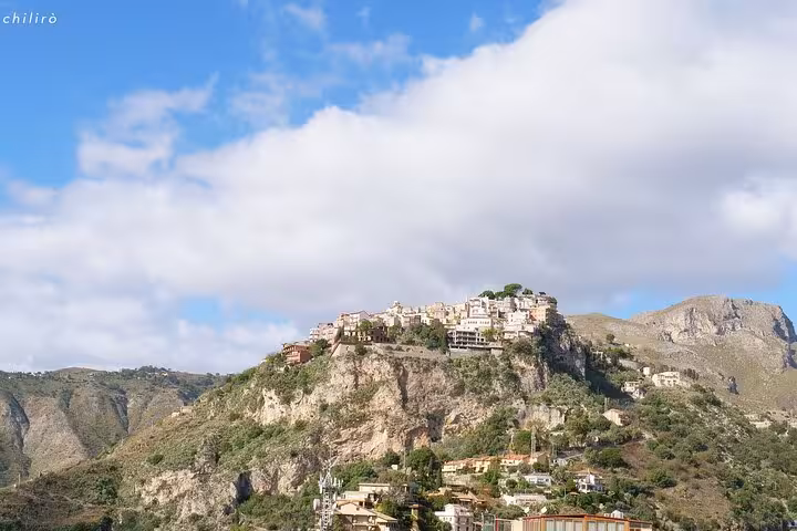 Discover Castelmola's picturesque hillside village perched atop rugged cliffs, ideal for scenic tours in Sicily.