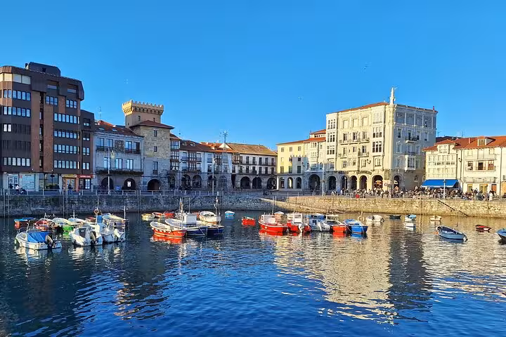 Picturesque harbor in Castro Urdiales with colorful boats and historic architecture, perfect for a day tour from Santander.