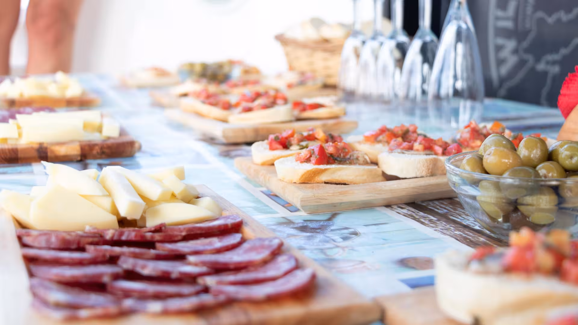 Delicious Italian antipasti spread on a catamaran lunch featuring local cheeses, meats, and bruschetta on Asinara tour.