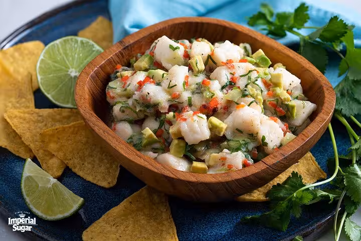 Vibrant ceviche bowl with fresh lime and tortilla chips, perfect for a boozy Panamanian cooking class experience.