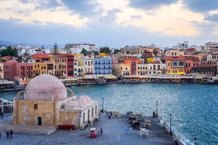 Chania Old Venetian Harbor with colorful waterfront and mosque, a highlight of the Rethymno day trip tour