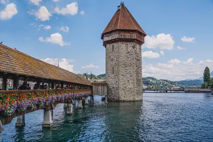 Scenic view of Chapel Bridge and Water Tower in Lucerne, Switzerland, perfect for exploring Swiss cultural landmarks.