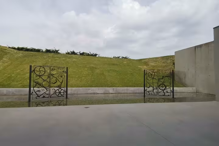 Contemporary art gates and reflecting pool at Château La Coste, Provence wine estate discovery tour
