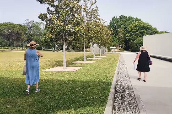 Guests stroll the landscaped grounds at Château La Coste on a Provence wine and art discovery tour