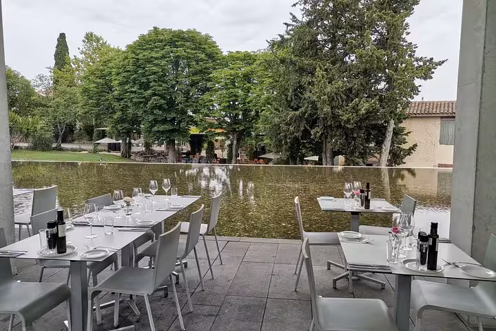 Al fresco dining terrace by a reflecting pond at Château La Coste, Provence wine tasting experience